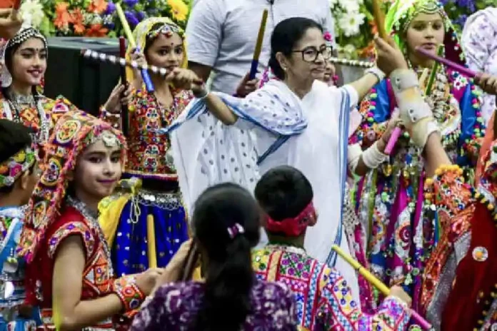 Mamata Banerjee performs the ‘dandiya’ as she takes part in a ‘Holi Milan’ event in Calcutta on Monday. PTI photo